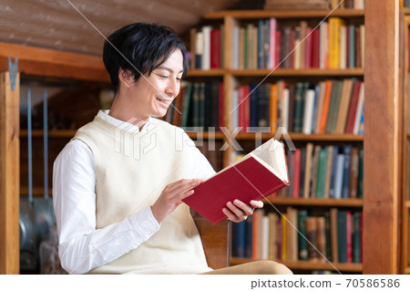 Autumn of reading: A smiling literary youth reading a book in the attic Autumn of reading: A smiling literary youth reading a book in the attic 70586586