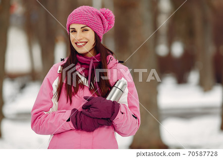 Woman in winter sports clothes looking at camera Woman in winter sports clothes looking at camera 70587728
