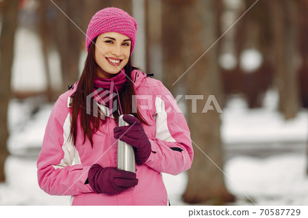 Woman in winter sports clothes looking at camera 70587729