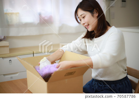 Woman doing packing work 70587786