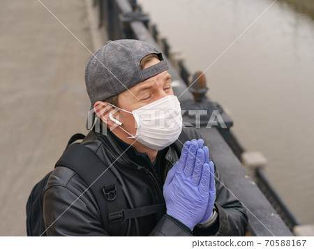 Man wearing protective mask outdoors. Coronavirus pandemic time. Man wearing protective mask outdoors. Coronavirus pandemic time. 70588167