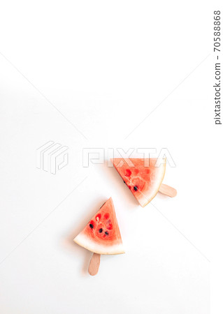 Ripe slice of watermelon in the form of a lelen on a stick on a white background. Healthy food. 70588868