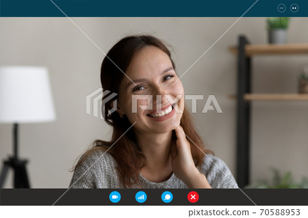 Head shot portrait screen view smiling young woman chatting online Head shot portrait screen view smiling young woman chatting online 70588953
