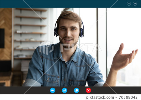 Head shot portrait screen view smiling man wearing headset speaking 70589042