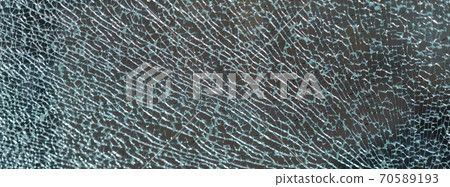 The geometry of the cracking glass. Glass breaking symmetry. The glass surface. White and green colors. Suitable as natural background. Free space for message The geometry of the cracking glass. Glass breaking symmetry. The glass surface. White and green colors. Suitable as natural background. Free space for message 70589193