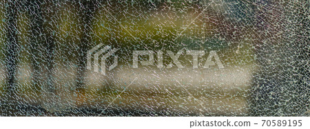The geometry of the cracking glass. Glass breaking symmetry. The glass surface. White and green colors. Suitable as natural background. Free space for message The geometry of the cracking glass. Glass breaking symmetry. The glass surface. White and green colors. Suitable as natural background. Free space for message 70589195