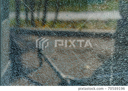 The geometry of the cracking glass. Glass breaking symmetry. The glass surface. White and green colors. Suitable as natural background. Free space for message The geometry of the cracking glass. Glass breaking symmetry. The glass surface. White and green colors. Suitable as natural background. Free space for message 70589196