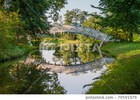 White pedestrian bridge with reflection White pedestrian bridge with reflection 70591979