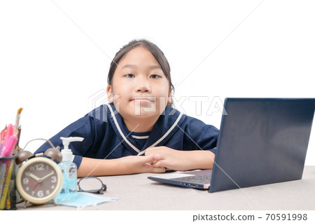 Happy cute girl watching videos streaming online on her laptop at home isolated on white. 70591998
