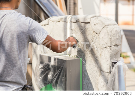 Plasterer painting the gatepost Plasterer painting the gatepost 70592903