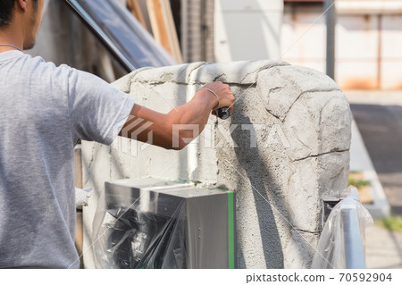 Plasterer painting the gatepost Plasterer painting the gatepost 70592904