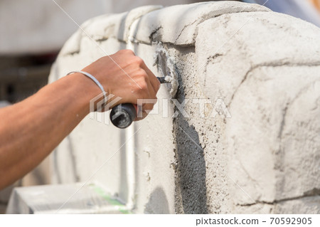 Plasterer painting the gatepost Plasterer painting the gatepost 70592905