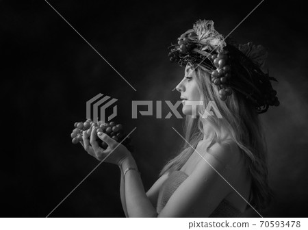 Portrait of  beautiful caucasian blonde woman with grapes. 70593478