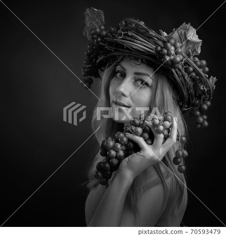 Portrait of beautiful caucasian blonde woman with grapes. Portrait of beautiful caucasian blonde woman with grapes. 70593479