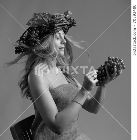 Portrait of beautiful caucasian blonde woman with grapes. Portrait of beautiful caucasian blonde woman with grapes. 70593480