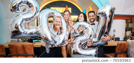 Group of party people celebrating the arrival of 2021 70593963
