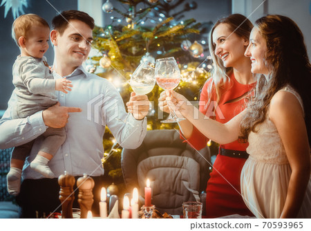Family and friends drinking wine on Christmas eve Family and friends drinking wine on Christmas eve 70593965
