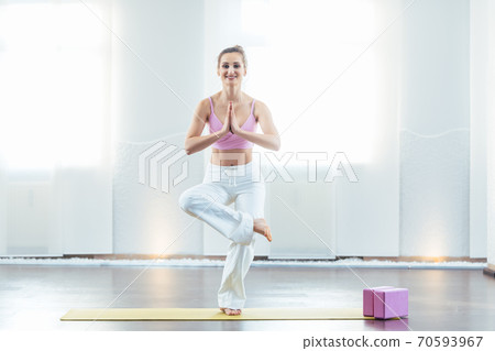 Beautiful yoga instructor in her studio 70593967