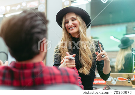 Woman Barber or hair stylist shaking hands with client Woman Barber or hair stylist shaking hands with client 70593973