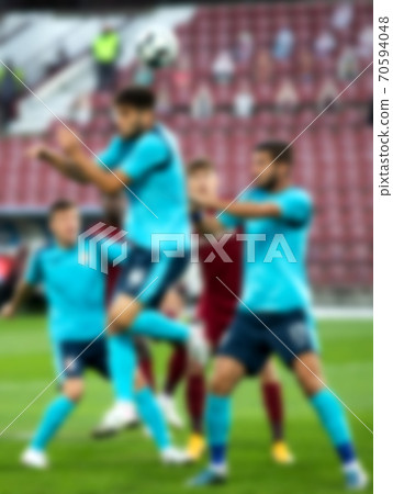 blurred background of soccer players during football game 70594048