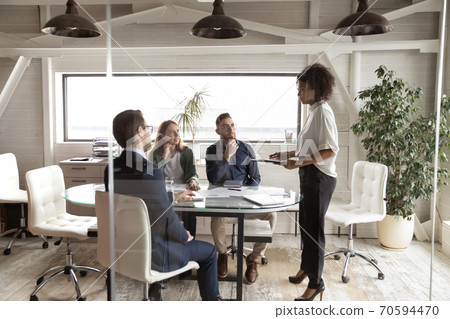 African ethnicity female business trainer educating interested diverse manager. 70594470