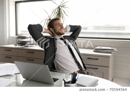 Relaxed young happy businessman enjoying break time. Relaxed young happy businessman enjoying break time. 70594564