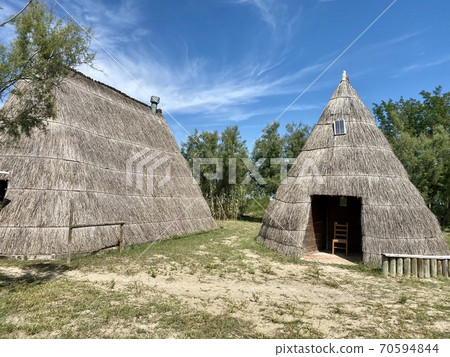 Typical old fisher houses made of reed in the beautiful lagoon of Caorle near Venice in Italy 70594844