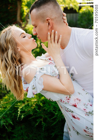beautiful and happy couple having fun in garden. 70595088