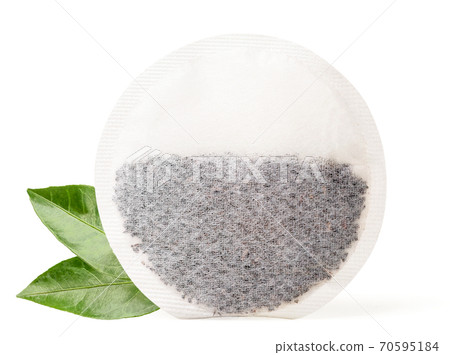 Round tea bag and fresh green leaves on white background. Isolated 70595184