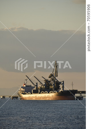 Photographed the autumn scenery of a cargo ship and a conveyor belt unloading to a cement factory in Hokuto City, Hokkaido in the early morning Photographed the autumn scenery of a cargo ship and a conveyor belt unloading to a cement factory in Hokuto City, Hokkaido in the early morning 70595906