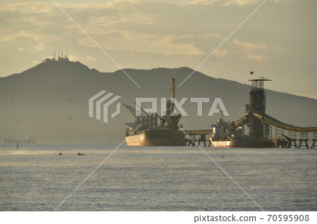 Photographed the autumn scenery of a cargo ship and a conveyor belt unloading to a cement factory in Hokuto City, Hokkaido in the early morning Photographed the autumn scenery of a cargo ship and a conveyor belt unloading to a cement factory in Hokuto City, Hokkaido in the early morning 70595908