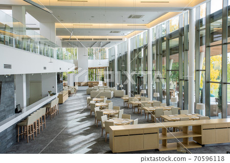 White chairs standing around square served tables and along bar counter 70596118