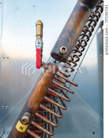 Bent brass pipes of water air cooling industrial unit 70596591