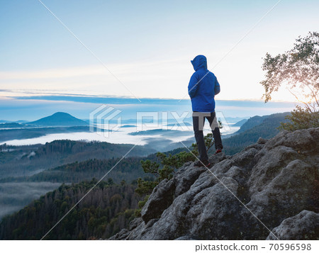 Hiking in sunrise. Man hiking in sunset in mountain 70596598