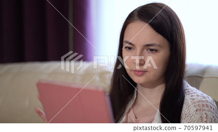 Woman Uses a Tablet at Home During Quarantine. Works Alone From Home Remotely. Quarantine Covid-19 Corona Virus. Social Distancing Concept. 70597941