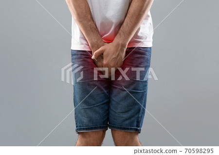 Close up of man holding his crotch 70598295