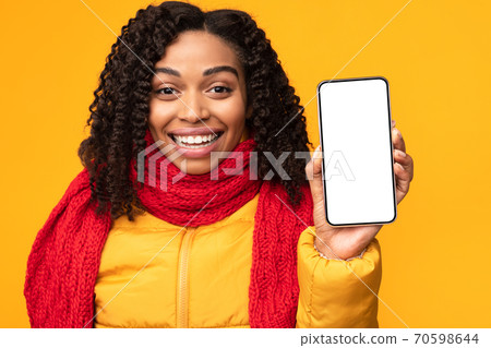 Joyful African Lady Showing Phone Screen To Camera, Yellow Background Joyful African Lady Showing Phone Screen To Camera, Yellow Background 70598644