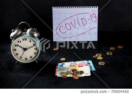 Covid 19 economical crisis in Europe, economical consequences of lockdowns. A clock, monthly calendar and money 70604488