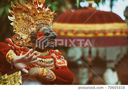 Dancer man in traditional Balinese costume and Topeng Wayang mask 70605816