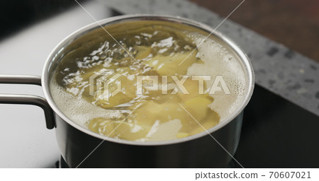 potato wedges boiling in saucepan potato wedges boiling in saucepan 70607021