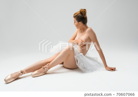 Topless young ballet dancer cover breast in pointe shoes an tutu 70607066