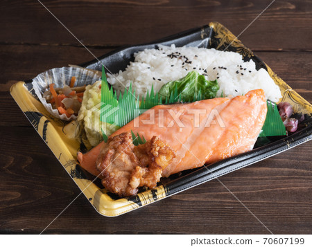 A supermarket lunch box with grilled salmon and fried chicken. A supermarket lunch box with grilled salmon and fried chicken. 70607199