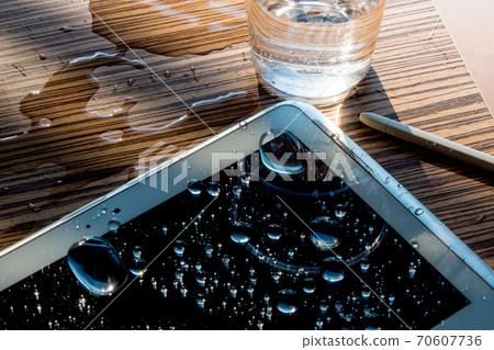 Drops of water on tablet screen Drops of water on tablet screen 70607736