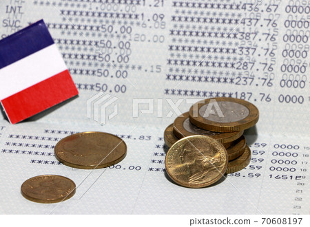 Heap of French franc coin money and mini France flag on the book bank. Concept of Saving money. 70608197