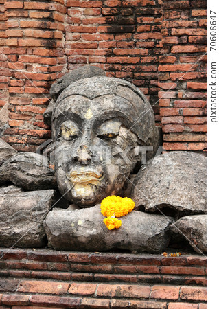 The ruins of stone Buddha pile together in the ruins and ancient church at Wat Worachet temple The ruins of stone Buddha pile together in the ruins and ancient church at Wat Worachet temple 70608647