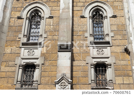 The facade of the old ancient church with four windows and bars. Iglesia del Sagrado Corazon de Jesus 70608761