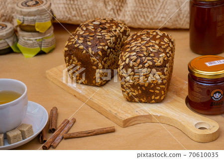 Grain baked brean on wooden board Grain baked brean on wooden board 70610035