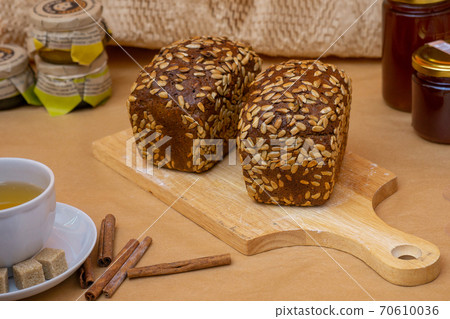 Grain baked brean on wooden board Grain baked brean on wooden board 70610036