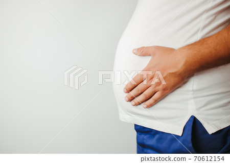Overweight man holding big belly, copy space 70612154