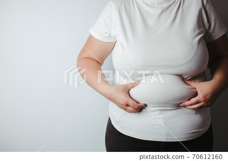 Overweight woman holding big belly, copy space 70612160